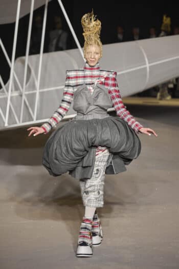 Thom Browne NYFW 2023: tartan and tweed rollneck red and grey long sleeved top with oversized grey balloon skirt